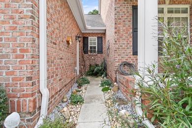 This beautiful home is nestled on a completely landscaped wooded on Lockwood Folly Country Club in North Carolina - for sale on GolfHomes.com, golf home, golf lot