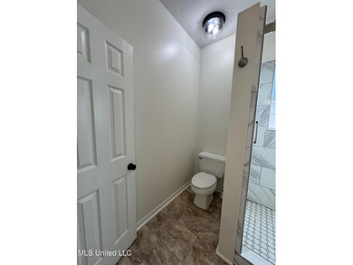 Welcome home to this recently updated 3-bedroom, 2-bath brick on Diamondhead Country Club in Mississippi - for sale on GolfHomes.com, golf home, golf lot