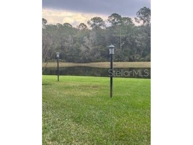 In the beautiful community of Hunters Green, where massive trees on Hunters Green Country Club in Florida - for sale on GolfHomes.com, golf home, golf lot