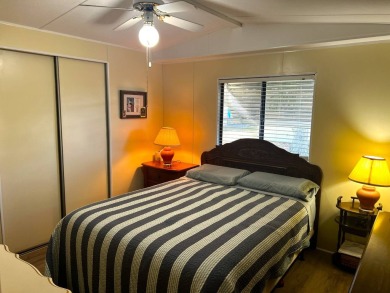 This charming home features two bedrooms and one and a half on Lake Henry Golf Club in Florida - for sale on GolfHomes.com, golf home, golf lot