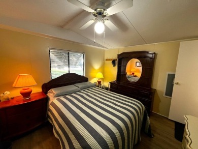 This charming home features two bedrooms and one and a half on Lake Henry Golf Club in Florida - for sale on GolfHomes.com, golf home, golf lot