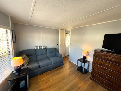 This charming home features two bedrooms and one and a half on Lake Henry Golf Club in Florida - for sale on GolfHomes.com, golf home, golf lot