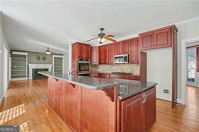 Tucked away on a quiet, double cul-de-sac street is the stately on Brookstone Golf and Country Club in Georgia - for sale on GolfHomes.com, golf home, golf lot