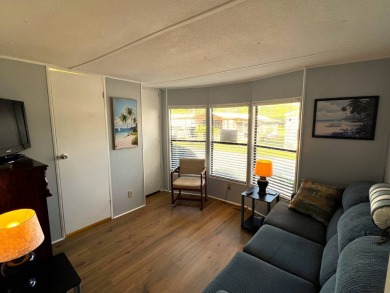 This charming home features two bedrooms and one and a half on Lake Henry Golf Club in Florida - for sale on GolfHomes.com, golf home, golf lot