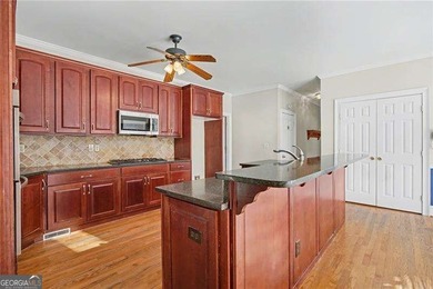 Tucked away on a quiet, double cul-de-sac street is the stately on Brookstone Golf and Country Club in Georgia - for sale on GolfHomes.com, golf home, golf lot