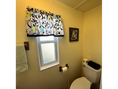 This charming home features two bedrooms and one and a half on Lake Henry Golf Club in Florida - for sale on GolfHomes.com, golf home, golf lot