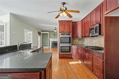 Tucked away on a quiet, double cul-de-sac street is the stately on Brookstone Golf and Country Club in Georgia - for sale on GolfHomes.com, golf home, golf lot