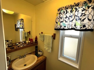 This charming home features two bedrooms and one and a half on Lake Henry Golf Club in Florida - for sale on GolfHomes.com, golf home, golf lot