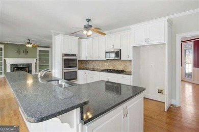 Tucked away on a quiet, double cul-de-sac street is the stately on Brookstone Golf and Country Club in Georgia - for sale on GolfHomes.com, golf home, golf lot