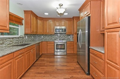 Lovely CBS 3 bedroom, 2 bath, 2 car garage split plan home with on Martin Downs Country Club in Florida - for sale on GolfHomes.com, golf home, golf lot