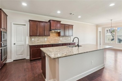 Nestled in the sought-after Traditions of Braselton golf course on Traditions of Braselton Golf Club in Georgia - for sale on GolfHomes.com, golf home, golf lot
