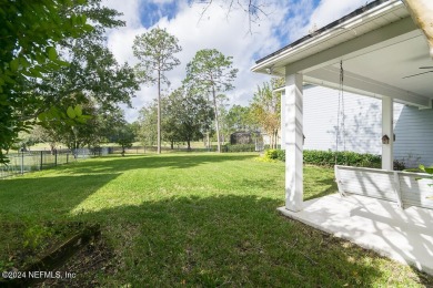 This elegant two story sits on a spectacular half-acre corner on St. Johns Golf and Country Club in Florida - for sale on GolfHomes.com, golf home, golf lot