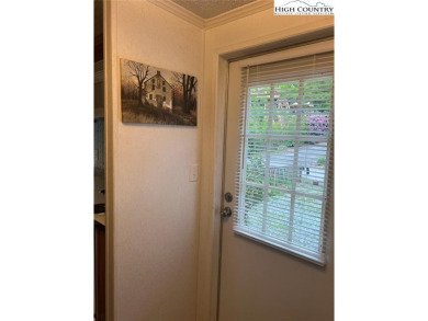 This little log siding home is the perfect weekender or 3 season on Land Harbor Golf Course in North Carolina - for sale on GolfHomes.com, golf home, golf lot