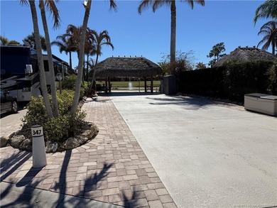 Nestled within an exclusive gated RV resort, this exceptional on St. Lucie Trail Golf Club in Florida - for sale on GolfHomes.com, golf home, golf lot