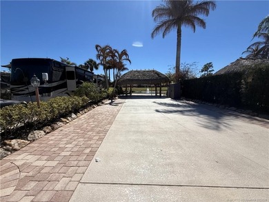 Nestled within an exclusive gated RV resort, this exceptional on St. Lucie Trail Golf Club in Florida - for sale on GolfHomes.com, golf home, golf lot
