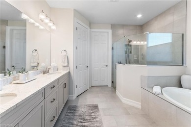 DESIGNER HOME WITH LAKE VIEW, OVERSIZED THREE CAR GARAGE & on Bonita National Golf Course in Florida - for sale on GolfHomes.com, golf home, golf lot