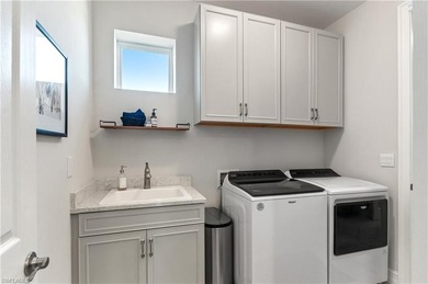 DESIGNER HOME WITH LAKE VIEW, OVERSIZED THREE CAR GARAGE & on Bonita National Golf Course in Florida - for sale on GolfHomes.com, golf home, golf lot