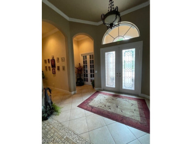 Step into the covered entry and elegant foyer, a formal dining on Estero Country Club in Florida - for sale on GolfHomes.com, golf home, golf lot