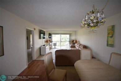 Discover convenience, and scenic beauty in this lovely 2-bedroom on Inverrary Country Club in Florida - for sale on GolfHomes.com, golf home, golf lot