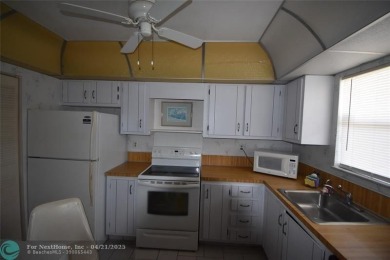 Discover convenience, and scenic beauty in this lovely 2-bedroom on Inverrary Country Club in Florida - for sale on GolfHomes.com, golf home, golf lot