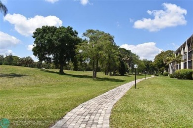 Discover convenience, and scenic beauty in this lovely 2-bedroom on Inverrary Country Club in Florida - for sale on GolfHomes.com, golf home, golf lot