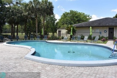 Discover convenience, and scenic beauty in this lovely 2-bedroom on Inverrary Country Club in Florida - for sale on GolfHomes.com, golf home, golf lot