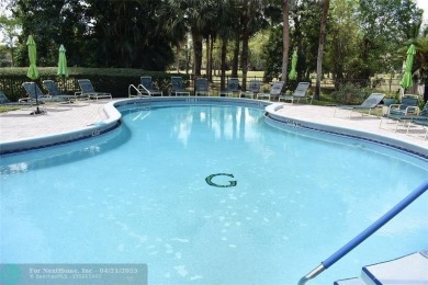 Discover convenience, and scenic beauty in this lovely 2-bedroom on Inverrary Country Club in Florida - for sale on GolfHomes.com, golf home, golf lot