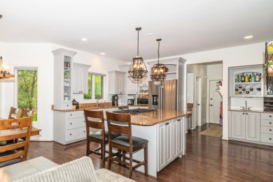 New wood floors throughout the main level welcome you to this on Travis Pointe Country Club in Michigan - for sale on GolfHomes.com, golf home, golf lot