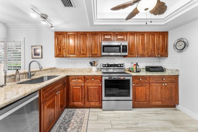 Immaculate first floor end-unit townhome showcasing tranquil on Riverbend Golf Club in Florida - for sale on GolfHomes.com, golf home, golf lot