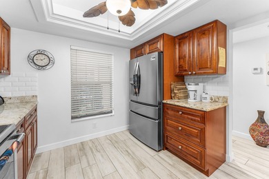 Immaculate first floor end-unit townhome showcasing tranquil on Riverbend Golf Club in Florida - for sale on GolfHomes.com, golf home, golf lot