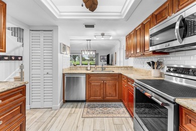 Immaculate first floor end-unit townhome showcasing tranquil on Riverbend Golf Club in Florida - for sale on GolfHomes.com, golf home, golf lot