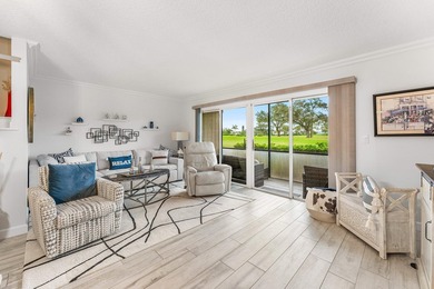 Immaculate first floor end-unit townhome showcasing tranquil on Riverbend Golf Club in Florida - for sale on GolfHomes.com, golf home, golf lot