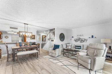 Immaculate first floor end-unit townhome showcasing tranquil on Riverbend Golf Club in Florida - for sale on GolfHomes.com, golf home, golf lot