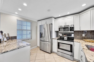 This fully remodeled unit features an open kitchen with white on Palm-Aire Country Club and Resort - Palms in Florida - for sale on GolfHomes.com, golf home, golf lot