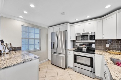 This fully remodeled unit features an open kitchen with white on Palm-Aire Country Club and Resort - Palms in Florida - for sale on GolfHomes.com, golf home, golf lot