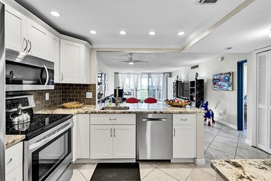 This fully remodeled unit features an open kitchen with white on Palm-Aire Country Club and Resort - Palms in Florida - for sale on GolfHomes.com, golf home, golf lot