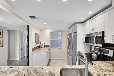 This fully remodeled unit features an open kitchen with white on Palm-Aire Country Club and Resort - Palms in Florida - for sale on GolfHomes.com, golf home, golf lot