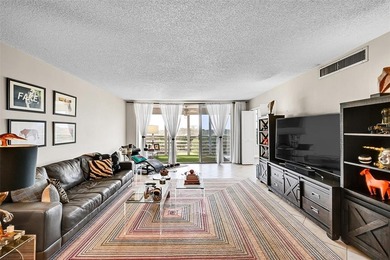 This fully remodeled unit features an open kitchen with white on Palm-Aire Country Club and Resort - Palms in Florida - for sale on GolfHomes.com, golf home, golf lot