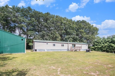 Welcome to 13660 18 Mile Rd., Gowen - a peaceful country retreat on The Links of Bowen Lake in Michigan - for sale on GolfHomes.com, golf home, golf lot