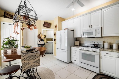 Enjoy stunning water views and abundant natural light in this on Viera East Golf Club in Florida - for sale on GolfHomes.com, golf home, golf lot