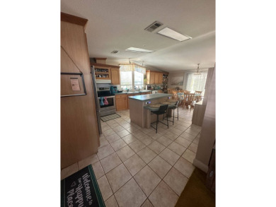Welcome to Your Spacious Triple-Wide Retreat with Pond Views! on Schalamar Creek Golf and Country Club in Florida - for sale on GolfHomes.com, golf home, golf lot