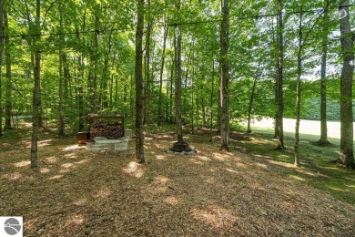 Tucked away in a private setting with frontage on the 13th hole on Schuss Mountain Golf Club in Michigan - for sale on GolfHomes.com, golf home, golf lot