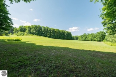 Tucked away in a private setting with frontage on the 13th hole on Schuss Mountain Golf Club in Michigan - for sale on GolfHomes.com, golf home, golf lot