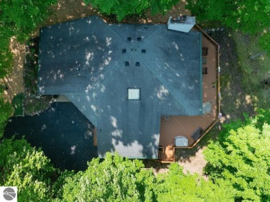 Tucked away in a private setting with frontage on the 13th hole on Schuss Mountain Golf Club in Michigan - for sale on GolfHomes.com, golf home, golf lot