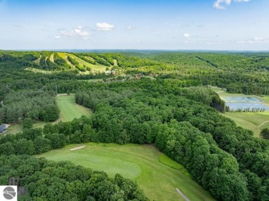 Tucked away in a private setting with frontage on the 13th hole on Schuss Mountain Golf Club in Michigan - for sale on GolfHomes.com, golf home, golf lot