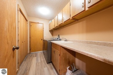 Tucked away in a private setting with frontage on the 13th hole on Schuss Mountain Golf Club in Michigan - for sale on GolfHomes.com, golf home, golf lot