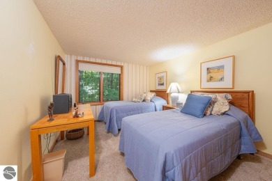 Tucked away in a private setting with frontage on the 13th hole on Schuss Mountain Golf Club in Michigan - for sale on GolfHomes.com, golf home, golf lot