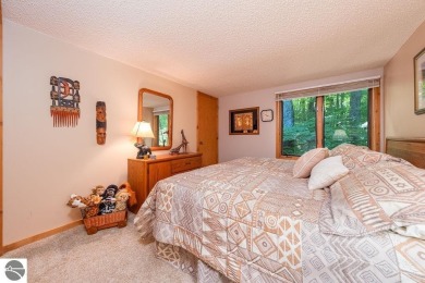 Tucked away in a private setting with frontage on the 13th hole on Schuss Mountain Golf Club in Michigan - for sale on GolfHomes.com, golf home, golf lot