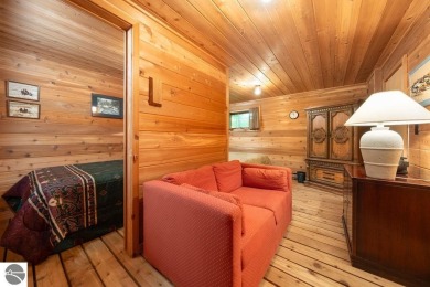 Tucked away in a private setting with frontage on the 13th hole on Schuss Mountain Golf Club in Michigan - for sale on GolfHomes.com, golf home, golf lot