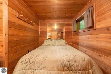 Tucked away in a private setting with frontage on the 13th hole on Schuss Mountain Golf Club in Michigan - for sale on GolfHomes.com, golf home, golf lot